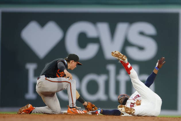 Boston Red Sox Andruw Monasterio is tagged out by Baltimore Orioles second baseman Jackson Holliday after rolling away from the base during the third inning at Fenway Park in Boston, Massachusetts on Wednesday, July 22, 2026.  BOP20260722011 CJxGUNTHER
