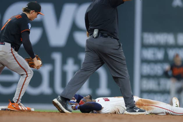 Boston Red Sox Andruw Monasterio lies on the e infield after being tagged out by Baltimore Orioles second baseman Jackson Holliday after rolling away from the base during the third inning at Fenway Park in Boston, Massachusetts on Wednesday, July 22, 2026.  BOP20260722202 CJxGUNTHER