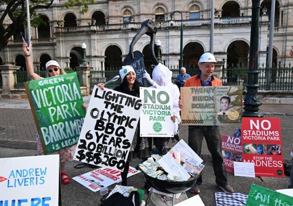 OLYMPICS MONEY BURNING 2032 BBQ, Protestors against the 2032 Brisbane Olympics are seen during a Olympics Money Burning BBQ protest that marks 6 years until the Brisbane 2032 Olympics, at Queensland Parliament House, in Brisbane, Thursday, July 23, 2026. ( NO ARCHIVING BRISBANE QUEENSLAND AUSTRALIA  Copyright: xDARRENxENGLANDx 20260723189001174590