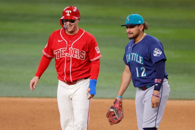 July 24, 2026, Arlington, Texas, USA: Texas Rangers designated hitter JOC PEDERSON (3) laughs with Seattle Mariners first baseman JOSH NAYLOR (12) after reaching on a single in the fifth inning during a baseball game, Friday, July 24, 2026, in Arlington, Texas. Arlington USA - ZUMAa325 20260724_zsa_a325_011 Copyright: xDavidxBalleringxIix