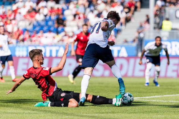 WIESBADEN, GERMANY - JULY 25: Tim Binder (FC Bayern Muenchen, 31) controls the ball against Justin Janitzek (SV Wehen Wiesbaden, 15) - penalty foul - during the friendly game between SV Wehen Wiesbaden vs. FC Bayern Muenchen at BRITA Arena on July 25, 2026 in Wiesbaden, Germany. Hessen Germany Copyright: xSteffiexWunderlx