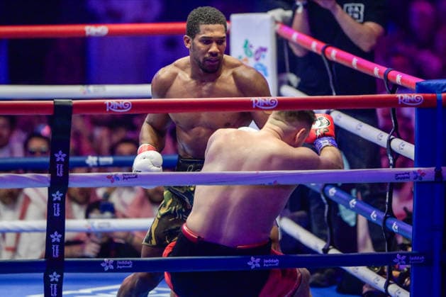 JEDDAH, SAUDI ARABIA - JULY 25: Anthony Joshua looks on as Kristian Prenga (red, black and gold shorts) falls to the ground during the Heavyweight contest fight between Anthony Joshua and Kristian Prenga in the Anthony Joshua v Kristian Prenga: The Comeback fight night at Jeddah Superdome on July 25, 2026 in Jeddah, Saudi Arabia.  Copyright: xKhalidxAlhaj MBxMediax