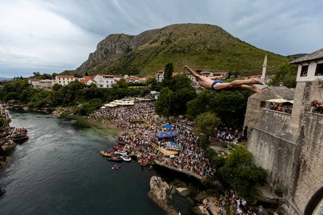 Mostar Old Bridge Diving Competition A participant dives from historical Old Bridge , also known as Mostar Bridge during the traditional diving competition event, 460th Traditional Mostar Old Bridge Diving Competition, in Mostar, Bosnia and Herzegovina on July 26, 2026. Each year, thousands of spectators watch the event across the Old Bridge that crosses Neretva river.  DenisxKapetanovic PIXSELL
