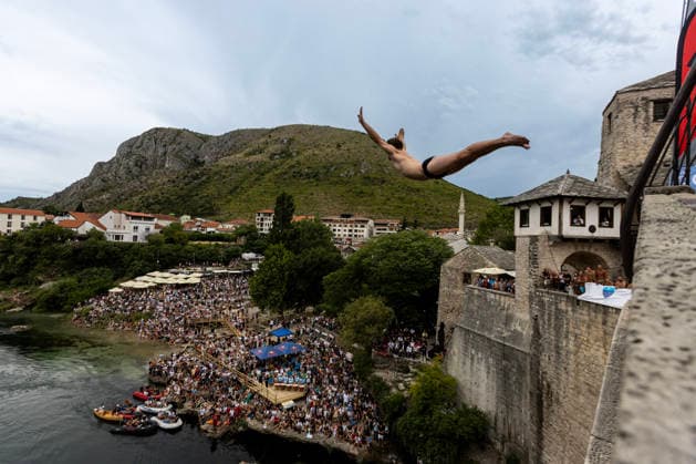 Mostar Old Bridge Diving Competition A participant dives from historical Old Bridge , also known as Mostar Bridge during the traditional diving competition event, 460th Traditional Mostar Old Bridge Diving Competition, in Mostar, Bosnia and Herzegovina on July 26, 2026. Each year, thousands of spectators watch the event across the Old Bridge that crosses Neretva river.  DenisxKapetanovic PIXSELL