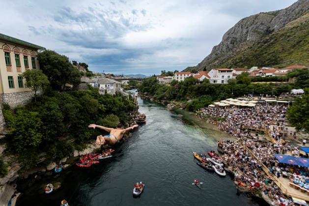 Mostar Old Bridge Diving Competition A participant dives from historical Old Bridge , also known as Mostar Bridge during the traditional diving competition event, 460th Traditional Mostar Old Bridge Diving Competition, in Mostar, Bosnia and Herzegovina on July 26, 2026. Each year, thousands of spectators watch the event across the Old Bridge that crosses Neretva river.  DenisxKapetanovic PIXSELL
