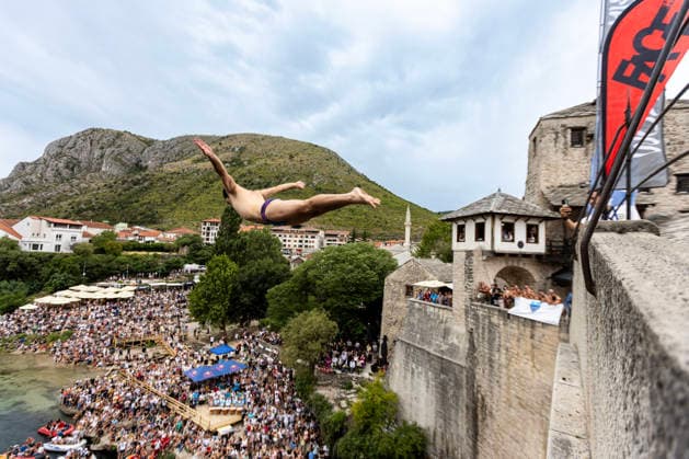 Mostar Old Bridge Diving Competition A participant dives from historical Old Bridge , also known as Mostar Bridge during the traditional diving competition event, 460th Traditional Mostar Old Bridge Diving Competition, in Mostar, Bosnia and Herzegovina on July 26, 2026. Each year, thousands of spectators watch the event across the Old Bridge that crosses Neretva river.  DenisxKapetanovic PIXSELL