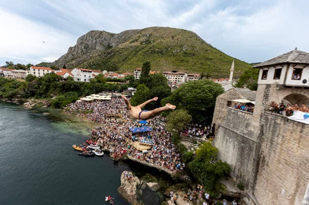 Mostar Old Bridge Diving Competition A participant dives from historical Old Bridge , also known as Mostar Bridge during the traditional diving competition event, 460th Traditional Mostar Old Bridge Diving Competition, in Mostar, Bosnia and Herzegovina on July 26, 2026. Each year, thousands of spectators watch the event across the Old Bridge that crosses Neretva river.  DenisxKapetanovic PIXSELL
