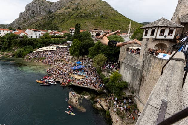 Mostar Old Bridge Diving Competition A participant dives from historical Old Bridge , also known as Mostar Bridge during the traditional diving competition event, 460th Traditional Mostar Old Bridge Diving Competition, in Mostar, Bosnia and Herzegovina on July 26, 2026. Each year, thousands of spectators watch the event across the Old Bridge that crosses Neretva river.  DenisxKapetanovic PIXSELL