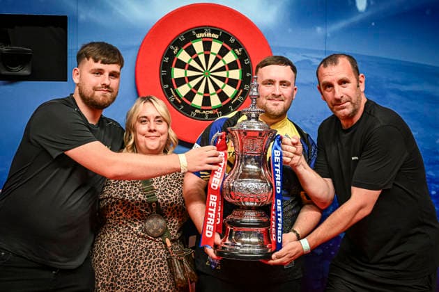 RECORD DATE NOT STATED 26th July 2026, Winter Gardens, Blackpool, Lancashire, England; 2026 Betfred World Matchplay Darts, Mens, Final Day; Luke Littler celebrates winning his final match against Gerwyn Price and holds the Betfred World Matchplay trophy with his family GodfreyxPitt