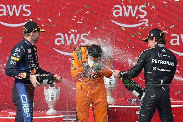 (260727) -- MOGYOROD, July 27, 2026 -- Red Bull s Dutch driver Max Verstappen (L), McLaren s Lando Norris (C) of Britain, and Mercedes Andrea Kimi Antonelli of Italy celebrate during the awarding ceremony after the Formula One Hungarian Grand Prix at the Hungaroring in Mogyorod, near Budapest, Hungary, July 26, 2026. (Photo by Xinhua) (SP)HUNGARY-MOGYOROD-F1-HUNGARIAN GRAND PRIX-RACE AttilaxVolgyi 