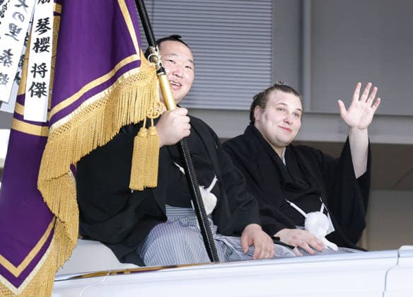 Nagoya Grand Sumo Tournament Sekiwake Aonishiki (R) waves to fans during a parade held after he won the 15-day Nagoya Grand Sumo Tournament in Nagoya, central Japan, on July 26, 2026.  A14AA0005624091P