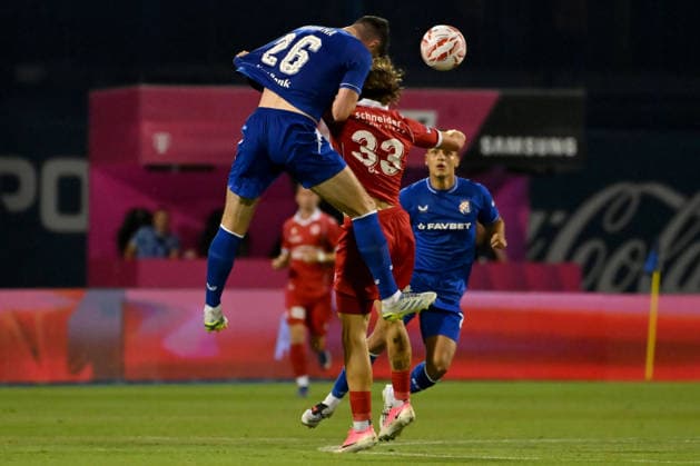 ZAGREB; CROATIA - JULY 28: Scott McKenna of Dinamo Zagreb (L) in action against Marc Gutbub of Thun (R) during the UEFA Champions League QR-2 second match between Dinamo Zagreb (CRO) and Thun (SUI) at Stadion Maksimir, Zagreb on July 28, 2026 in Zagreb, Croatia. (Photo by Igor Kupljenik Sports Press Photo).  Copyright: xIgorxKupljenikx xSPPx Sportspressphoto_SPR198053