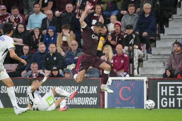 UK: Heart of Midlothian v SK Sturm Graz - Champions League 2nd Qualifying Round at Tynecastle Park in Edinburgh , Scotland on 28 July 2026 Heart of Midlothian v SK Sturm Graz - Champions League 2nd Qualifying Round at Tynecastle Park in Edinburgh , Scotland on 28 July 2026 Oisin McEntee of Hearts leaps over the tackle of Emran Soglo of Sturm Graz Edinburgh Tynecastle Park Scotland Copyright: xJamesxChristiex