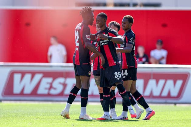 29.07.2026, Fußball, Bayer 04 Leverkusen - KRC Genk, Testspiel, Saison 2026 2027 im Ulrich-Haberland-Stadion: Torjubel nach dem Tor zum 4:0 durch Torschütze Christian Kofane (Bayer04 Leverkusen 35) zusammen mit Edmond Tapsoba (Bayer04 Leverkusen 12) Jeanuel Belocian (Bayer04 Leverkusen 44) DFB regulations prohibit any use of photographs as image sequences and or quasi-video. Nordrhein-Westfalen Deutschland *** July 29, 2026, Soccer, Bayer 04 Leverkusen vs. KRC Genk, Friendly Match, 2026–2027 season at Ulrich Haberland Stadium; celebration after the 4–0 goal scored by Christian Kofane (Bayer 04 Leverkusen 35), together with Edmond Tapsoba (Bayer 04 Leverkusen 12) and Jeanuel Belocian (Bayer 04 Leverkusen 44); DFB regulations prohibit any use of photographs as image sequences and or quasi-video. North Rhine-Westphalia, Germany