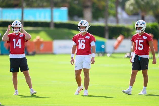 MIAMI GARDENS, FL - JULY 29: Miami Dolphins quarterbacks Quinn Ewers (14), Mark Gronowski (16) and Cam Miller (15) stand on the field during the Miami Dolphins Training Camp on August 29, 2026, at the Baptist Health Training Complex in Miami Gardens, FL. (Photo by Doug Murray Icon Sportswire) NFL, American Football Herren, USA JUL 29 Dolphins Training Camp EDITORIAL USE ONLY Icon796260729025