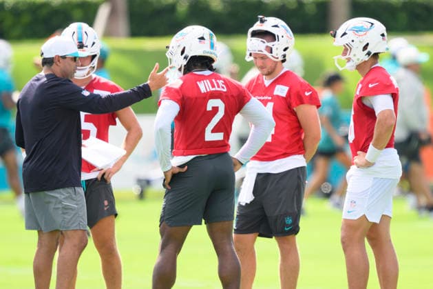 MIAMI GARDENS, FL - JULY 29: Miami Dolphins quarterbacks coach Bush Hamdan speaks with quarterback s Cam Miller (15), Malik Willis (2), Quinn Ewers (14) and Mark Gronowski (16) during the Miami Dolphins Training Camp on August 29, 2026, at the Baptist Health Training Complex in Miami Gardens, FL. (Photo by Doug Murray Icon Sportswire) NFL, American Football Herren, USA JUL 29 Dolphins Training Camp EDITORIAL USE ONLY Icon796260729038