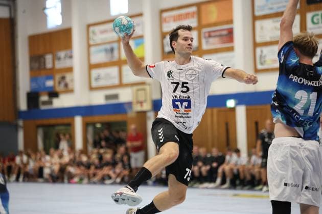 Tjorben Heckel ( 75; HSG Eider Harde) zieht in der Werner-Kuhrt-Halle in Hohn zum Sprungwurf hoch, während ein Spieler des THW Kiel den Arm hebt. Im Hintergrund verfolgen zahlreiche Zuschauer die Szene. Tjorben Heckel ( 75; HSG Eider Harde) beim Sprungwurf *** Tjorben Heckel 75 of HSG Eider Harde rises for a jump shot at the Werner Kuhrt Halle in Hohn, while a THW Kiel player raises his arm. In the background, numerous spectators watch the action. Tjorben Heckel 75 of HSG Eider Harde takes a jump shot. Copyright: xspeedshotx