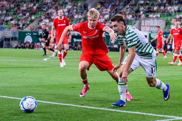 Budapest , 30-07-2026 , Groupama Arena , season 2026 2027 , UEFA Europa League play-off football , match between Ferencvarosi TC and FC Twente , picture shows FC Twente player Kristian Hlynsson Ferencvarosi player Marius Corbu Ferencvarosi - Twente  x205334803x Copyright: