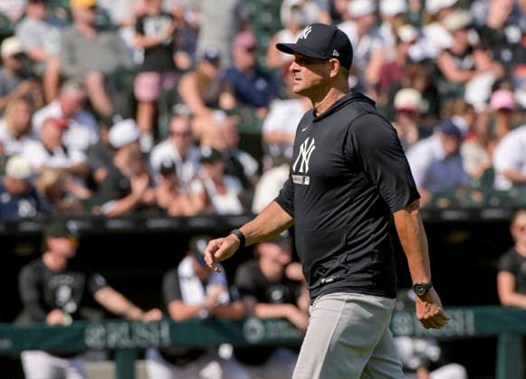 New York Yankees manager Aaron Boone walks from the mound after a pitching change against the Chicago White Sox during the tenth inning at Rate Field in Chicago, IL on Thursday, July 30, 2026. The White Sox defeated the Yankees 2-1.  CHI20260730135 MARKxBLACK
