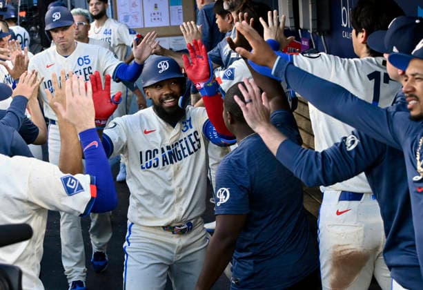 Los Angeles Dodger right fielder Teoscar Hernandez celebrates with teammates in the dugout after hitting a two-run homer in the second inning against the Boston Red Sox at Dodger Stadium in Los Angeles on Saturday, August 1, 2026.  LAP2026080110 JIMxRUYMEN