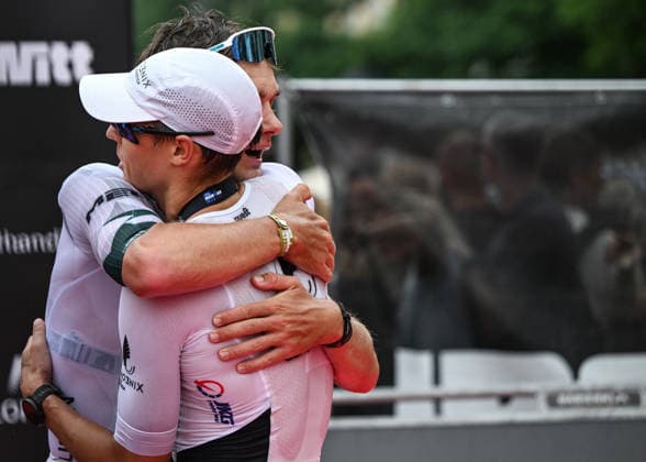 TRIATHLON: Stepniak And Bartlett Secure Elite Victories At IRONMAN 70.3 Krakow KRAKOW, POLAND - AUGUST 02: Race winner Kacper Stepniak of Poland (R) and runner-up Daniel Baekkegard of Denmark (L) embrace at the finish line following their close battle at the Enea IRONMAN 70.3 Krakow triathlon on the Main Market Square in Krakow, Lesser Poland Voivodeship, Poland, on August 02, 2026. Stepniak successfully defended his title with a time of 3:36:37, narrowly finishing ahead of Baekkegard who took second place in 3:36:57 after a 113-kilometer (70.3-mile) endurance course. Krakow Poland  Copyright: xArturxWidakx originalFilename:widak-triathlo260802_npFCS.jpg