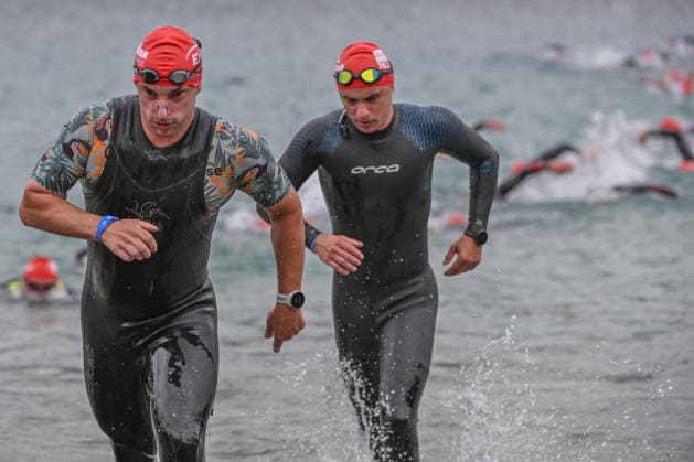 TRIATHLON: Stepniak And Bartlett Secure Elite Victories At IRONMAN 70.3 Krakow KRAKOW, POLAND - AUGUST 02: Triathletes sprint out of the water side-by-side during the swim-to-bike transition stage of the Enea IRONMAN 70.3 Krakow triathlon at the Zakrzowek Reservoir in Krakow, Lesser Poland Voivodeship, Poland, on August 02, 2026. Over 2,100 registered competitors completed the opening 1.9-kilometer open-water swim phase inside the flooded limestone quarry before rushing up the concrete exit ramp toward the first transition zone (T1) to begin the 90-kilometer cycling leg. Krakow Poland  Copyright: xArturxWidakx originalFilename:widak-triathlo260802_npHbN.jpg