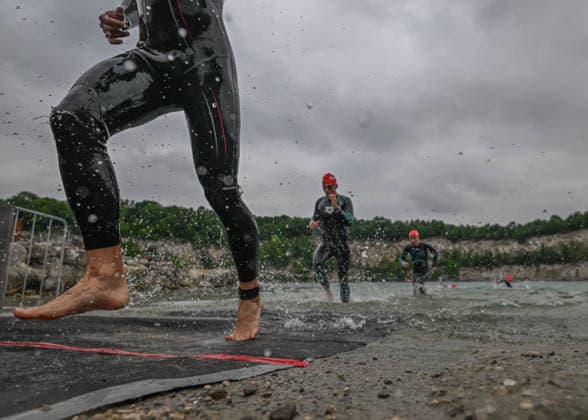TRIATHLON: Stepniak And Bartlett Secure Elite Victories At IRONMAN 70.3 Krakow KRAKOW, POLAND - AUGUST 02: Triathlete sprints out of the water next to a prominent Enea branding banner during the swim-to-bike transition stage of the Enea IRONMAN 70.3 Krakow triathlon at the Zakrzowek Reservoir in Krakow, Lesser Poland Voivodeship, Poland, on August 02, 2026. Over 2,100 registered competitors for the main 113-kilometer (70.3-mile) distance completed their opening 1.9-kilometer open-water swim inside the flooded limestone quarry before heading toward the Transition 1 (T1) zone to begin the cycling phase. Krakow Poland  Copyright: xArturxWidakx originalFilename:widak-triathlo260802_nplaU.jpg