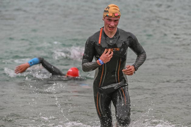 TRIATHLON: Stepniak And Bartlett Secure Elite Victories At IRONMAN 70.3 Krakow KRAKOW, POLAND - AUGUST 02: A triathlete exits the water while another competitor swims in the background during the swim-to-bike transition stage of the Enea IRONMAN 70.3 Krakow triathlon at the Zakrzowek Reservoir in Krakow, Lesser Poland Voivodeship, Poland, on August 02, 2026. Over 2,100 registered competitors completed the opening 1.9-kilometer open-water swim phase inside the flooded limestone quarry before rushing toward the first transition zone (T1) to begin the 90-kilometer cycling leg. Krakow Poland  Copyright: xArturxWidakx originalFilename:widak-triathlo260802_np7DI.jpg
