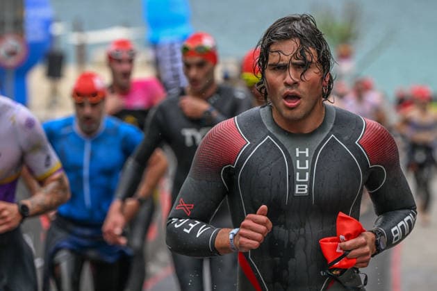 TRIATHLON: Stepniak And Bartlett Secure Elite Victories At IRONMAN 70.3 Krakow KRAKOW, POLAND - AUGUST 02: Triathlete wearing a black and red Huub Aegis X wetsuit sprints up the concrete exit ramp during the swim-to-bike transition stage of the Enea IRONMAN 70.3 Krakow triathlon at the Zakrzowek Reservoir in Krakow, Lesser Poland Voivodeship, Poland, on August 02, 2026. Following the professional waves, over 2,100 registered competitors for the main 113-kilometer (70.3-mile) distance completed their 1.9-kilometer open-water swim inside the flooded limestone quarry before rushing toward the Transition 1 (T1) zone to begin the cycling discipline. Krakow Poland  Copyright: xArturxWidakx originalFilename:widak-triathlo260802_npP8W.jpg