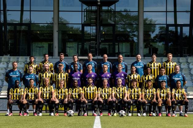 ARNHEM , 04-08-2026 , Nationaal Sportcentrum Papendal , season 2026 2027 , Dutch Keuken Kampioen Divisie football , Photocall , picture shows Vitesse squad with, back row L-R, Vitesse player Ayman Sellouf, Vitesse player Omar Achouitar, Vitesse performance coach Lars Smeenk, Vitesse assistant coach Timm Fahrion, Vitesse head coach Rudiger Rehm, Vitesse assistant coach Mike van Dijk, Vitesse goalkeeper coach Rein Baart, Vitesse physiotherapist Tijmen Gores, Vitesse player Koen te Veluwe, Vitesse player Eduard Probst, middle row L-R, Vitesse team manager Erwin Mulder, Vitesse kit manager Fabian van Drumpt, Vitesse player Valon Zumberi, Vitesse player Marcus Steffen, Vitesse goalkeeper Tyrick Bodak, Vitesse goalkeeper Connor van den Berg, Vitesse goalkeeper Maximilian Brull, Vitesse goalkeeper Jayden Siecker, Vitesse player Naoufal Bannis, Vitesse player Nathan Markelo, Vitesse video analyst Yuhao Zhang, Vitesse kit manager Leon Keijman, front row L-R, Vitesse player Solomon Bonnah, Vitesse player Youssef Ouallil, Vitesse player Chiel Olde Keizer, Vitesse player Mathijs Marschalk, Vitesse player Joao Pinto, Vitesse player Marco Schikora, Vitesse player Alexander Buttner, Vitesse player Nino Zonneveld, Vitesse player Yuval Ranon, Vitesse player Ricardo Schwarz, Vitesse player Filipe de Carvalho and Vitesse player Xiamaro Thenu pose for a teamphoto Photocall Vitesse  x205454198x Copyright: