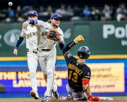 Milwaukee Brewers second baseman Brice Turang turns a double play on Pittsburgh Pirates second baseman Nick Gonzales after forcing out Pittsburgh Pirates catcher Endy Rodriguez f(R) in the seventh inning of the MLB, Baseball Herren, USA game between the Pittsburgh Pirates and the Milwaukee Brewers at American Family Field in Milwaukee, Wisconsin on Tuesday, August 4, 2026.  MIL20260804830 TANNENxMAURY