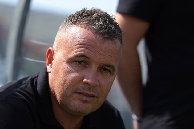 Biella, Italy, 5th August 2026. Mariglen Kule Head Coach of KFF Apolonia looks on from the bench prior to kick off in the Hammarby IF vs KFF Apolonia UEFA Womens Champions League 2nd Qualifying Round semi final match at Stadio Vittorio Pozzo, Biella. Picture credit should read: Jonathan Moscrop Sportimage EDITORIAL USE ONLY. No use with unauthorised audio, video, data, fixture lists, club league logos or live services. Online in-match use limited to 120 images, no video emulation. No use in betting, games or single club league player publications. SPI_003_JM_HAMMARBY_APOLONIA_UWCL SPI-4874-0003