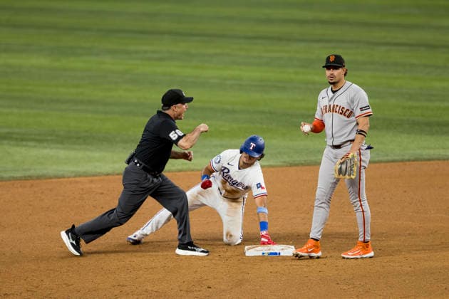 August 5, 2026, Arlington, Texas, USA: Texas Rangers shortstop NICKY LOPEZ (33) gets called out by umpire DAN IASSOGNA (58) at second base against the San Francisco Giants at Globe Life Field. Rangers win 6-0. MLB, Baseball Herren, USA 2026: Rangers 6:0 Giants  - ZUMAf180 20260805_zsp_f180_004 Copyright: xMarkxFannx
