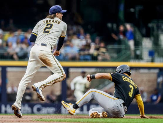 Milwaukee Brewers second baseman Brice Turang (L) forces out Pittsburgh Pirates third baseman Nick Gonzales (R) and turns a double play on Pittsburgh Pirates catcher Endy Rodriguez in the second inning of the MLB, Baseball Herren, USA game between the Pittsburgh Pirates and the Milwaukee Brewers at American Family Field in Milwaukee, Wisconsin on Wednesday, August 5, 2026.  MIL20260805808 TANNENxMAURY