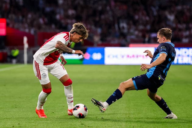 AMSTERDAM, NETHERLANDS - AUGUST 6: Maher Maurizio Carrizo of AFC Ajax dribbles with the ball under pressure from James Norris of Shelbourne FC during the UEFA Conference League 2026 27 third qualifying round first leg match between AFC Ajax and Shelbourne FC at the Johan Cruijff Arena on August 6, 2026 in Amsterdam, Netherlands.  Copyright: xRenexNijhuis MBxMediax