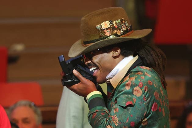 Former Carolina Panthers quarterback Cam Newton takes polaroid photos at the pro football hall of fame gold jacket ceremony in Canton, Ohio, on Friday, August 7, 2026.  CAN20260807142 AARONxJOSEFCZYK