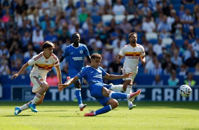 Yasin Ayari shoots to score the 3rd Brighton and Hove Albion goal watched by Mattia Mannini of AS Roma Brighton and Hove Albion v Roma, Pre Season Friendly, Football, American Express Community Stadium, Brighton, UK - 08 Aug 2026Brighton American Express Community Stadi United Kingdom EDITORIAL USE ONLY No use with unauthorised audio, video, data, fixture lists, club league logos or live services. Online in-match use limited to 120 images, no video emulation. No use in betting, games or single club league player publications.  Copyright: xMattxImpey Shutterstockx 17050873n