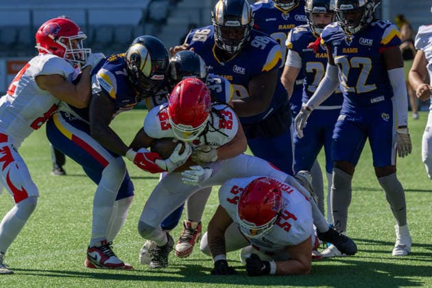 Firenze Red Lions wide receiver Mali Harris-Strayhorn ( 83) secures the football while tackled by Alpine Rams defender Ryan Johnson ( 7) during a rushing play. Fabio Teagno ( 54) falls to the turf alongside Ahmed Sofiano ( 98) as defenders swarm the pile.. Alpine Rams vs Firenze Red Lions, American Football, American Football League Europe, Week 12, 2026, 8.8.2026, Copyright: xPFA RicoxDoninellix