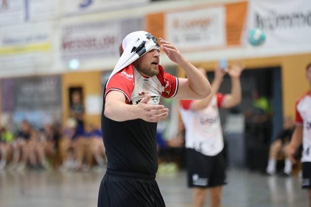 Ein Spieler von HÖJ Elite wischt sich mit dem Trikot das Gesicht ab und zeigt dabei sichtliche Erschöpfung oder Frustration. Im Hintergrund ist ein weiterer HÖJ-Elite-Spieler zu sehen. HÖJ-Elite-Spieler wischt sich Schweiß vom Gesicht in der KGS-Sporthalle *** A HÖJ Elite player wipes his face with his jersey, showing obvious exhaustion or frustration. Another HÖJ Elite player can be seen in the background. A HÖJ Elite player wipes sweat from his face in the KGS gym. Copyright: xspeedshotx