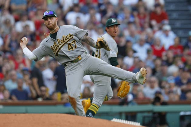 Athletics third baseman Tommy White makes a throw to first base as Athletics pitcher Gage Jump, right, looks on during the sixth inning against the Boston Red Sox at Fenway Park in Boston, Massachusetts on Saturday, August 8, 2026.  BOP2026080814 CJxGUNTHER