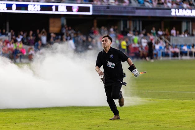 SAN JOSE, CA - AUGUST 08: A staff member carries off a flare during a Leagues Cup Phase One match between Chivas de Guadalajara and FC Dallas on August 8, 2026 at PayPal Park in San Jose, CA. (Photo by Matthew Huang Icon Sportswire) SOCCER: AUG 08 Leagues Cup Chivas de Guadalajara vs Dallas EDITORIAL USE ONLY Icon260808021