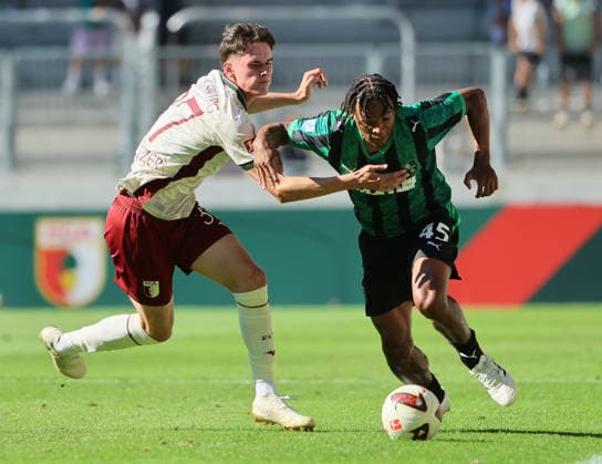 (260809) -- AUGSBURG, Aug. 9, 2026 -- Tim Schnitzer (L) of FC Augsburg vies with Armband Lauriente of Sassuolo during the friendly football match between FC Augsburg and Sassuolo in Augsburg, Germany, Aug. 8, 2026. (Photo by Xinhua) (SP)GERMANY-AUGSBURG-FOOTBALL-FRIENDLY MATCH-AUGSBURG VS SASSUOLO PhilippexRuiz 