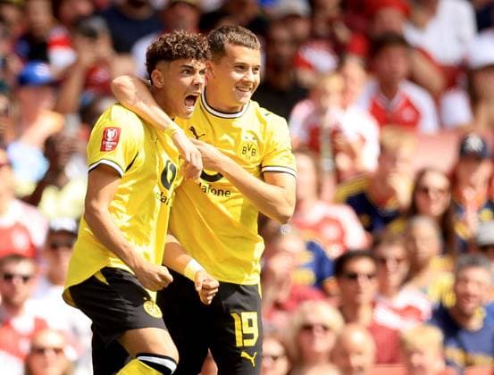 Samuele Inacio of Borussia Dortmund (left) celebrates with teammate Konstantino Karetsas after scoring their side s first goal of the game Arsenal v Borussia Dortmund, Pre Season Friendly, Football, Emirates Stadium, London, UK - 09 Aug 2026London Emirates Stadium United Kingdom EDITORIAL USE ONLY No use with unauthorised audio, video, data, fixture lists, club league logos or live services. Online in-match use limited to 120 images, no video emulation. No use in betting, games or single club league player publications.  Copyright: xGeorgexTewkesbury Shutterstockx 17051143n