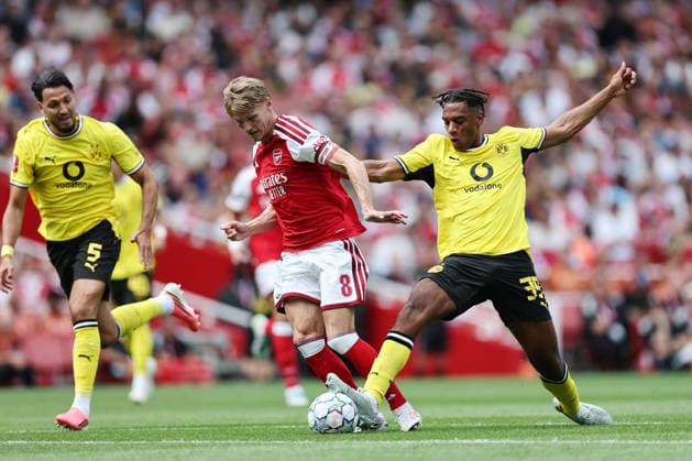 London, England, 9th August 2026. Arsenal™s Martin Odegaard gets tackled by Filippo Mane of Borussia Dortmund during the Arsenal vs Borussia Dortmund Pre Season Friendly match at the Emirates Stadium, London. Picture credit should read: David Klein Sportimage EDITORIAL USE ONLY. No use with unauthorised audio, video, data, fixture lists, club league logos or live services. Online in-match use limited to 120 images, no video emulation. No use in betting, games or single club league player publications. SPI_DK_004_Arsenal_Dortmund SPI-4895-0004