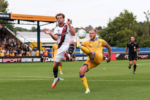Mansfield Town v Sheffield United, Carabao Cup Frazer Blake-Tracy of Mansfield Town and Patrick Bamford of Sheffield United battle for the ball during the Mansfield Town v Sheffield United Carabao Cup 1st Round match at Field Mill One Call Stadium, Mansfield, England on 9 August 2026 Credit: Richard Bierton Every Second Media Editorial use only. All images are copyright Every Second Media Limited. No images may be reproduced without prior permission. All rights reserved. Premier League and Football League images are subject to licensing agreements with Football DataCo Limited. see https: www.football-dataco.com Copyright: xIMAGO EveryxSecondxMediax ESM-2086-0051 RichardxBiertonx xEveryxSecondxMediax