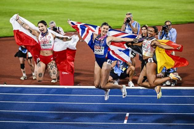L-R, second Poland s Ewa Swoboda, winner Great-Britain Amy Hunt and third Belgian Delphine Nkansa celebrate with their medals and flags after the final of the women s 100m race at the European Athletics Championships (August 10-18) in Birmingham, United Kingdom, on Monday 10 August 2026. ERICxLALMAND  x183110246x