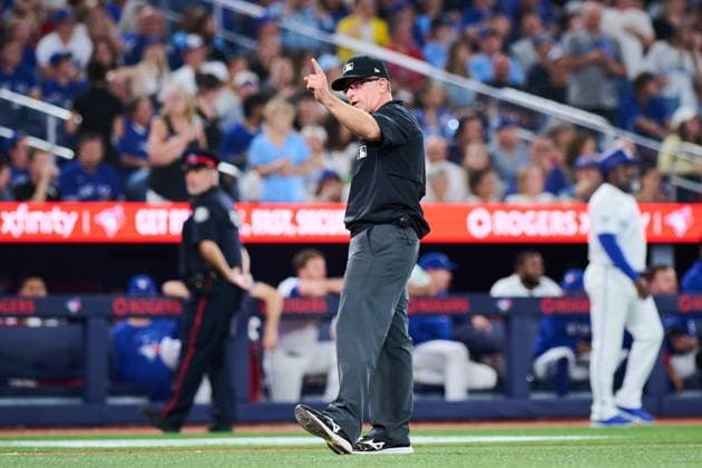 August 10, 2026, Toronto, On, Canada: Umpire Chris Guccione announces a rules check during an umpire review during seventh inning MLB, Baseball Herren, USA baseball action between the Toronto Blue Jays and the Boston Red Sox in Toronto, on Monday, Aug. 10, 2026. BBO-Red-Sox-Blue-Jays 20260810  - ZUMAc35_ 20260810_zaf_c35_139 Copyright: xSammyxKoganx