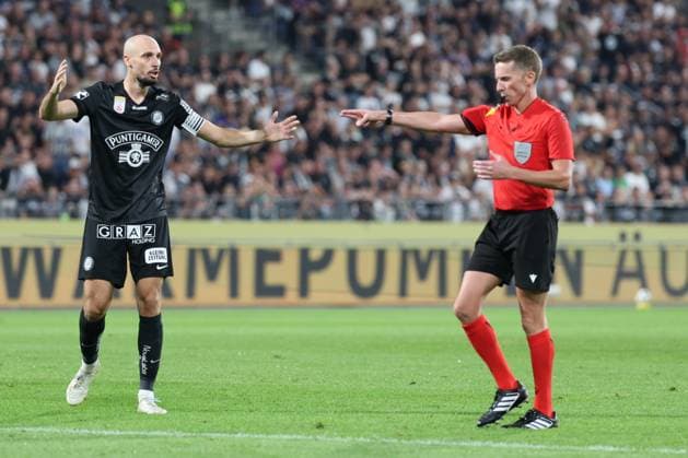 11 August 2026 - SOCCER - 2026 27 UEFA CHAMPIONS LEAGUE, Third Qualifying Round, 2nd Leg SK Sturm Graz vs Fenerbahce SK Jon Gorenc Stankovic (Sturm Graz) and Referee Alejandro Hernandez (ESP) signals for a penalty during the match. Graz Stadion Graz Liebenau Styria Austria Copyright: xYigitxOermex xPsxImagesxYigitxOermex xPsxImagesx