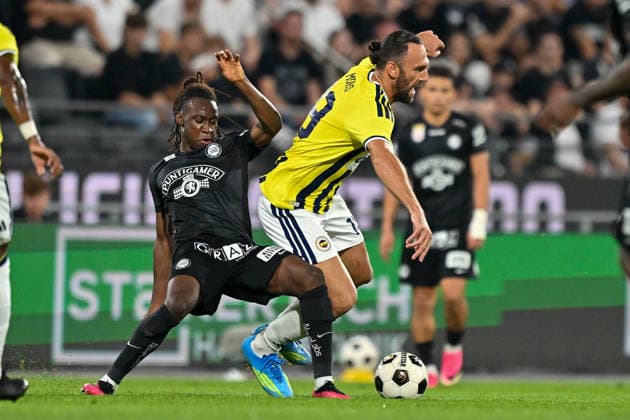 SOCCER - UEFA CL, Sturm vs Fenerbahce GRAZ,AUSTRIA,11.AUG.26 - SOCCER - UEFA Champions League, qualification, SK Sturm Graz vs Fenerbahce Istanbul. Image shows Ryan Fosso (Sturm) and Vedat Muriqi (Fenerbahce).  GEPAxpictures xAvnixRetkoceri
