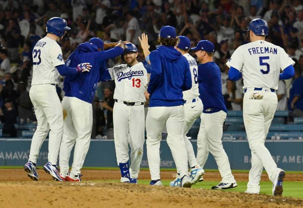 Los Angeles Dodgers Max Muncy (13) celebrates with teammates after hitting a walk-off RBI single in the tenth inning against the Kansas City Royals at Dodger Stadium in Los Angeles on Tuesday, August 11, 2026.  LAP2026081101 JIMxRUYMEN